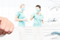 dentist hand touch screen on dental clinic with dentist's chair background web banner template, contact us concept